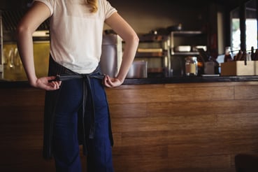 waitress-tying-apron-at-restaurant-3J2SQGN